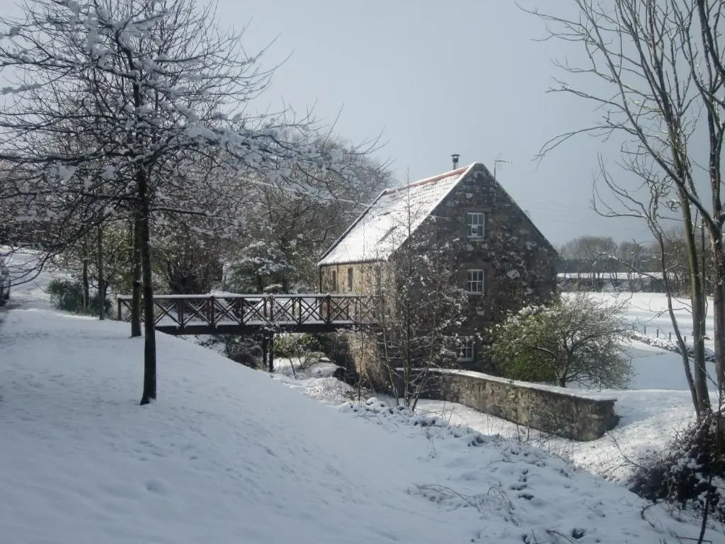 a barn in the snow with a bridge at Stunning Rural Mill House nr beach and harbour in Banff