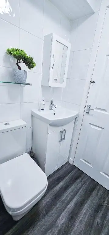 a white bathroom with a toilet and a sink at Cromarty 4 Bedroom Apartment - Inverness in Inverness