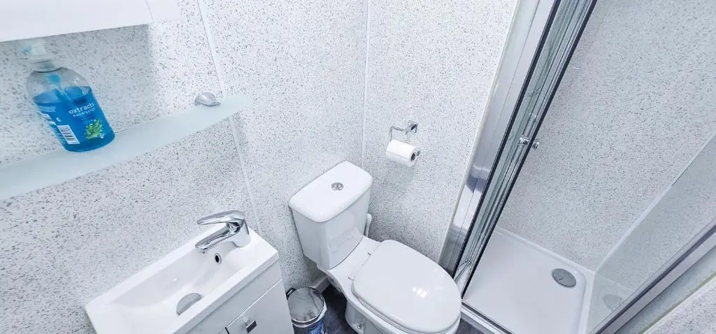 a white bathroom with a toilet and a sink at Lovat 2 Bedroom Apartment - Inverness in Inverness