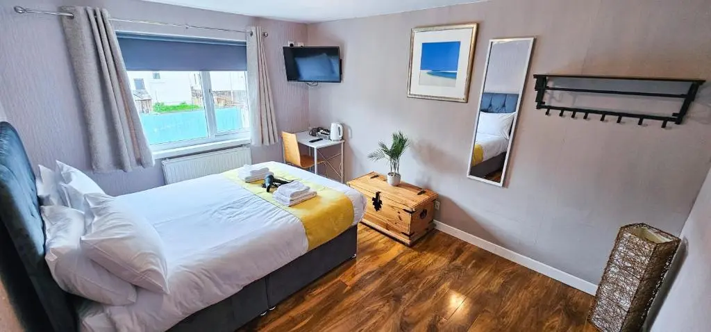 a small bedroom with a bed and a window at Lovat 2 Bedroom Apartment - Inverness in Inverness