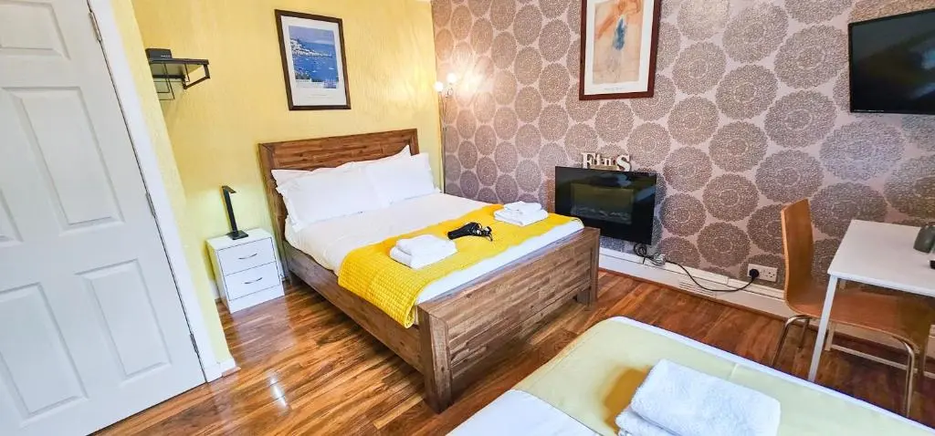 a bedroom with a bed and a tv and a couch at Fraser 2 Bedroom Apartment - Inverness in Inverness