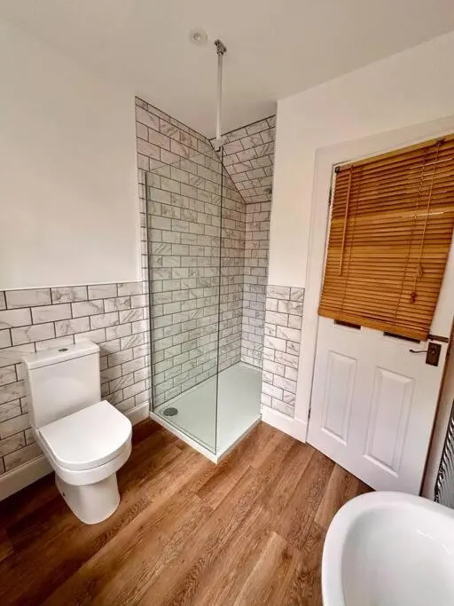 a bathroom with a toilet and a shower and a sink at Warm and Cosy City Centre House in Inverness