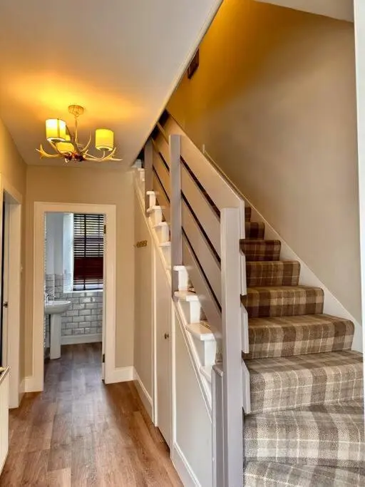 a staircase in a home with a stair case at Warm and Cosy City Centre House in Inverness