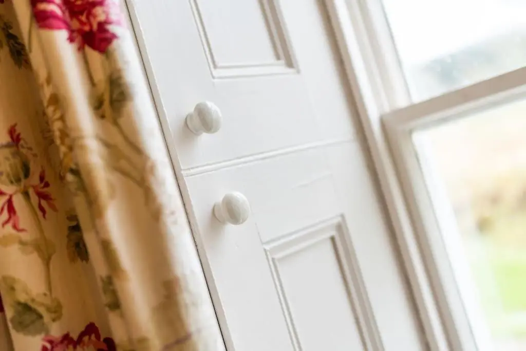 a door with a curtain next to a window at Westerpark Cottage, Pet & Family Friendly Countryside Retreat, Aberdeenshire in Huntly