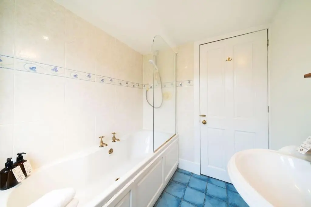 a bathroom with a tub and a sink at Westerpark Cottage, Pet & Family Friendly Countryside Retreat, Aberdeenshire in Huntly
