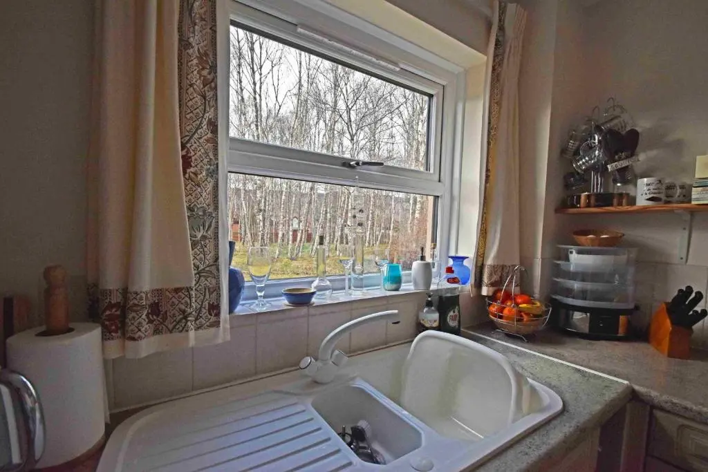 a kitchen with a sink and a window at Birch View in Aviemore