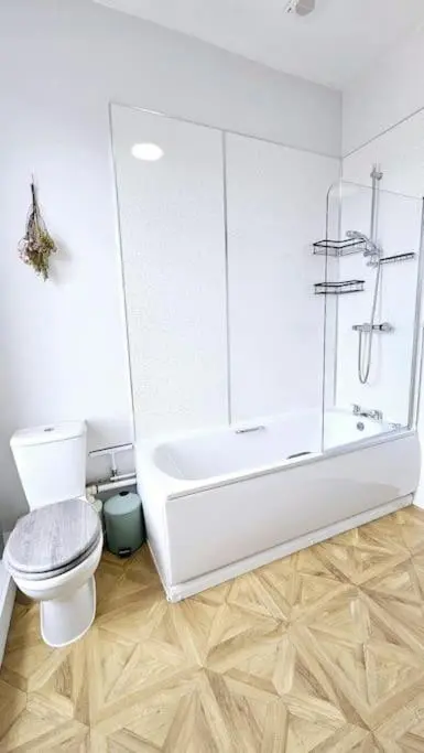 a white bathroom with a shower and a toilet at Charming 3-bedroom maisonnette in Inverness City Centre in Inverness