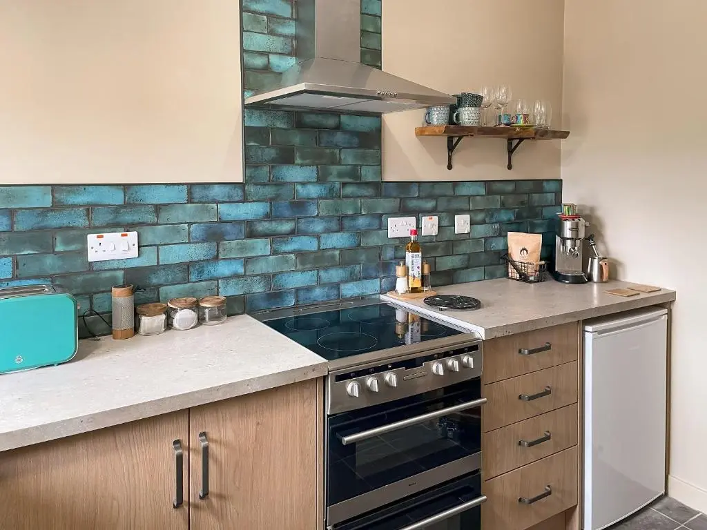a kitchen with a stove and a counter top at The Wee Belter in Dornoch