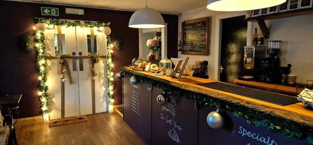 a kitchen with a bar with christmas garland at The Salt house in Golspie