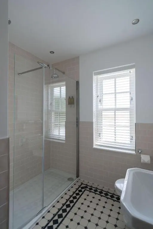 a bathroom with a shower and a toilet and a sink at The Forbes Arms Hotel in Alford