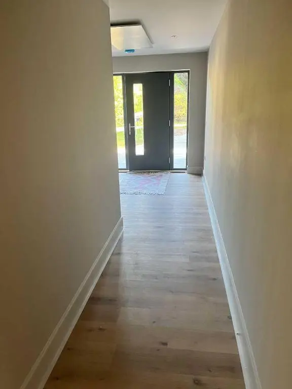 an empty room with a hallway with wood floors at Dune House, Golf Road, Dornoch 5x Bedrooms in Dornoch