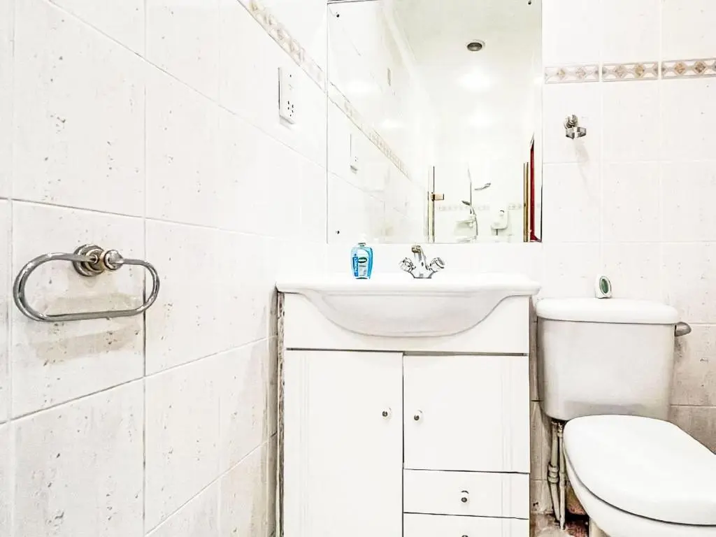 a white bathroom with a toilet and a sink at Chalet Oich View by Interhome in Spean Bridge