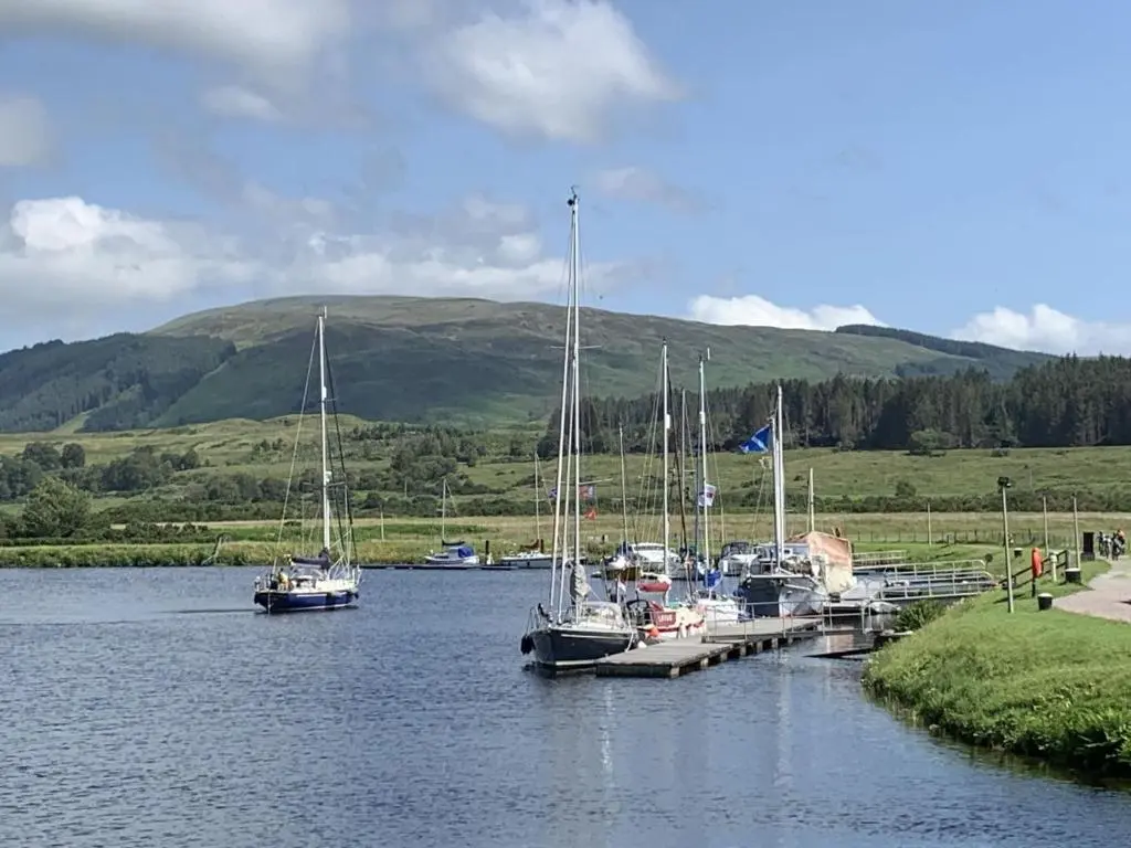 a group of boats docked at a dock in the water at Chalet Oich View by Interhome in Spean Bridge