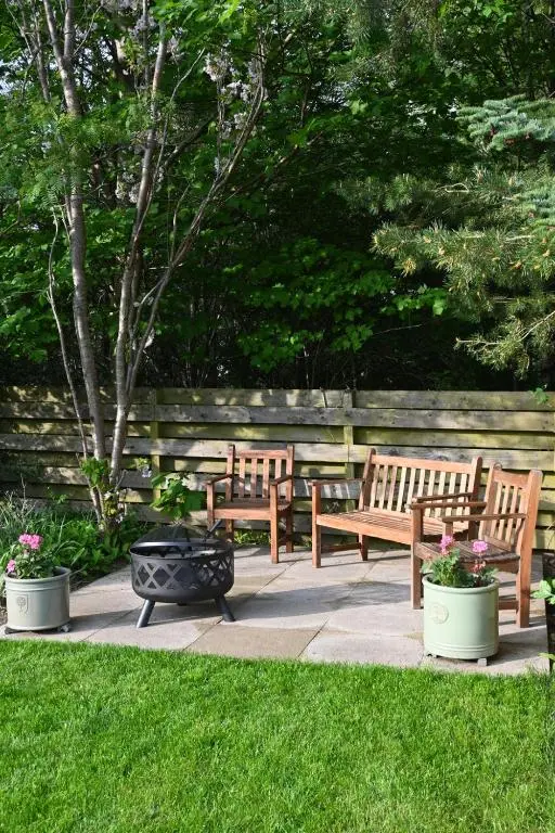 a group of benches sitting on a patio at Greenwood - Stunning Scandinavian Style Home in the heart of Ballater Royal Deeside in Ballater