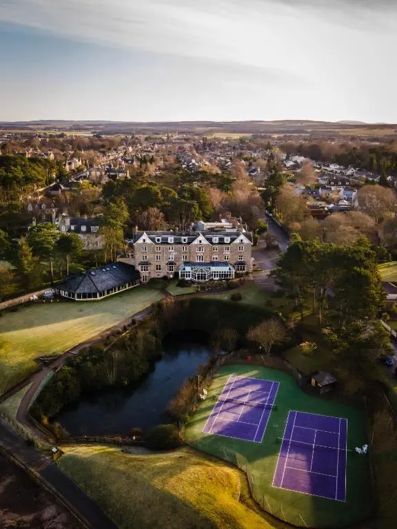 an aerial view of a house with a tennis court at Golf View Hotel & Spa in Nairn