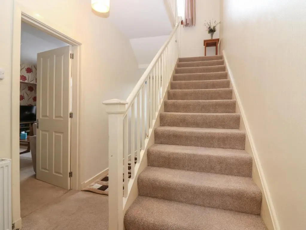 a staircase in a home with white walls at Thain House in Banff