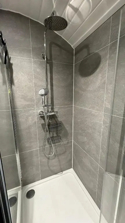 a bathroom with a shower with a shower at Juniper Lodges in Inverness