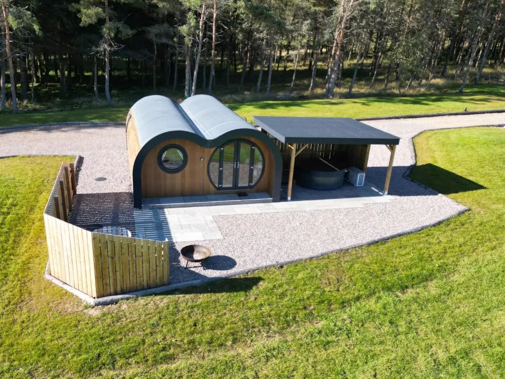 a small play house in a park with a table at Juniper Lodges in Inverness