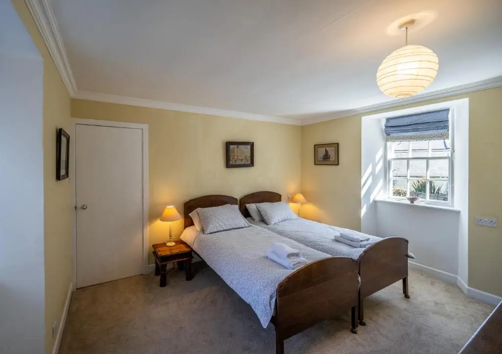 a bedroom with a bed and a window at 7 Shorehead, Portsoy in Portsoy