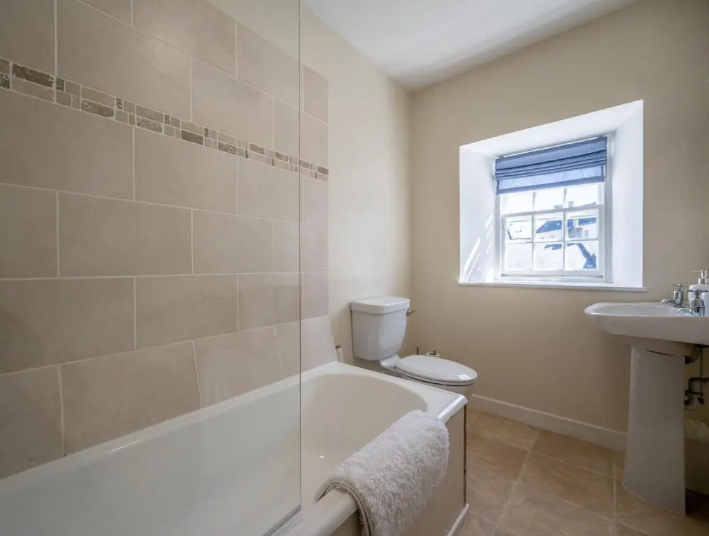 a bathroom with a tub and a toilet and a sink at 7 Shorehead, Portsoy in Portsoy