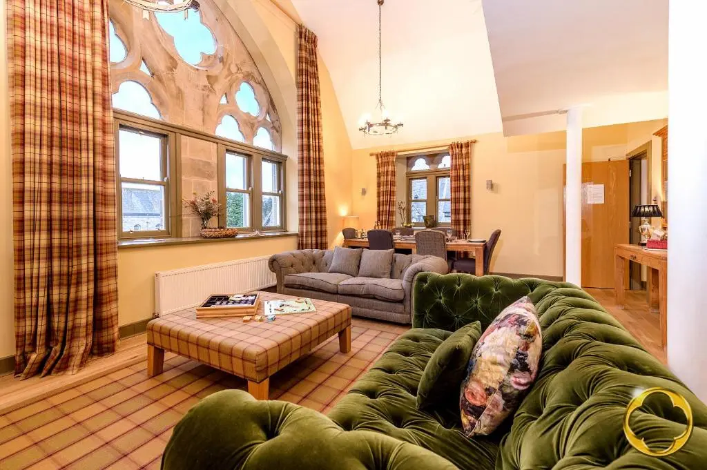 a living room with a couch and a table at Highland Club Direct in Fort Augustus