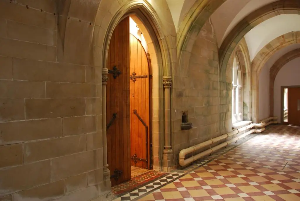 an empty hallway with a wooden door in a building at Highland Club Direct in Fort Augustus