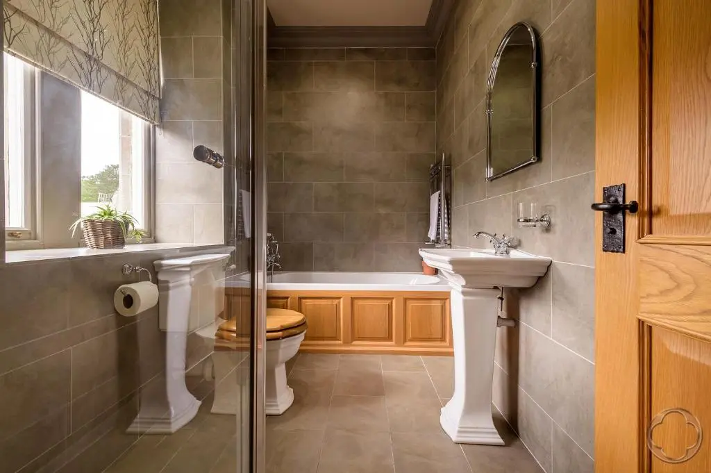 a bathroom with a tub and a toilet and a sink at Highland Club Direct in Fort Augustus