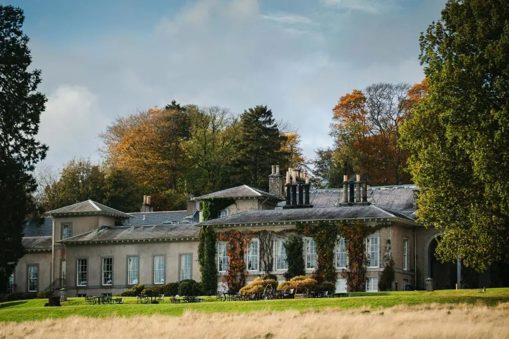 a large house with trees in the background at Thainstone House in Inverurie