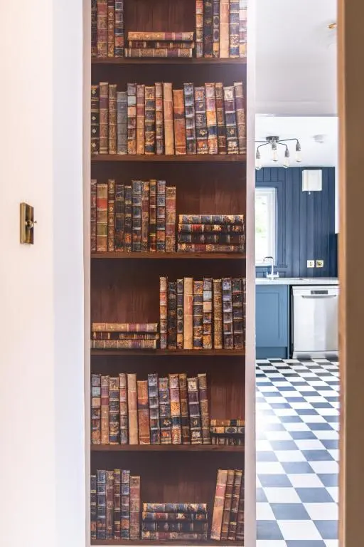 a book shelf filled with books in a kitchen at Lachie's Townhouse in Inverness