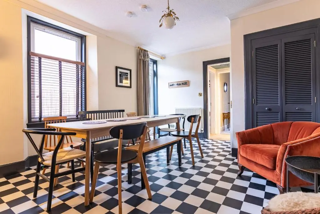 a dining room with a table and chairs at Lachie's Townhouse in Inverness