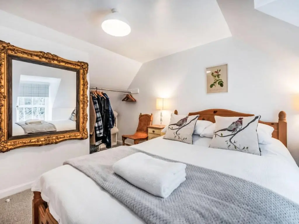 a bedroom with a bed and a mirror at Holiday Home Dancot by Interhome in Invermoriston