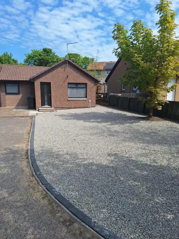 a brick house with a driveway in front of it at 5 Fulmar Road**Next to West Beach and Golf Course in Lossiemouth