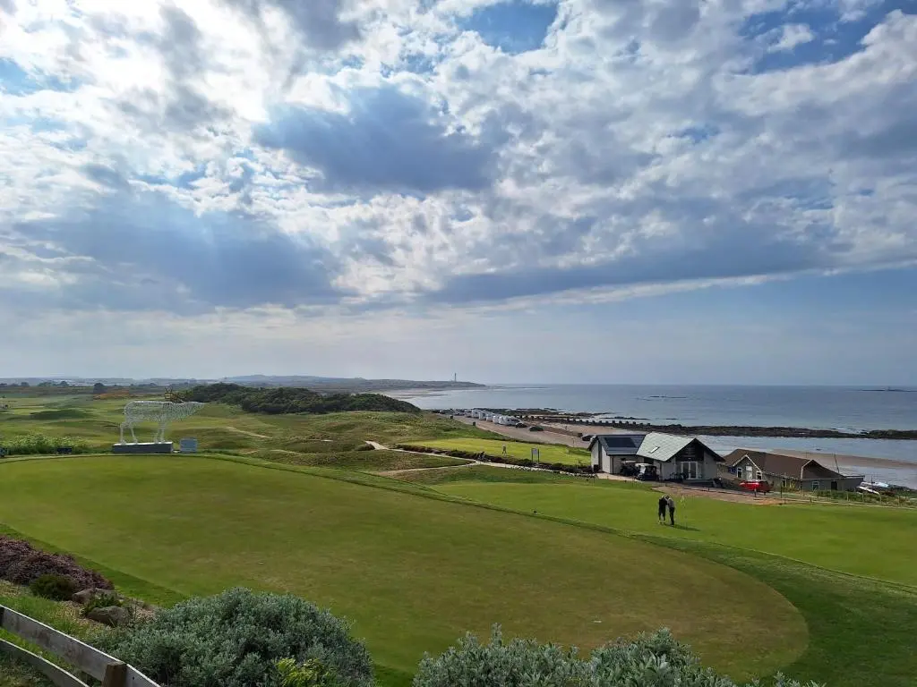 a person is playing golf on a green field at 5 Fulmar Road**Next to West Beach and Golf Course in Lossiemouth