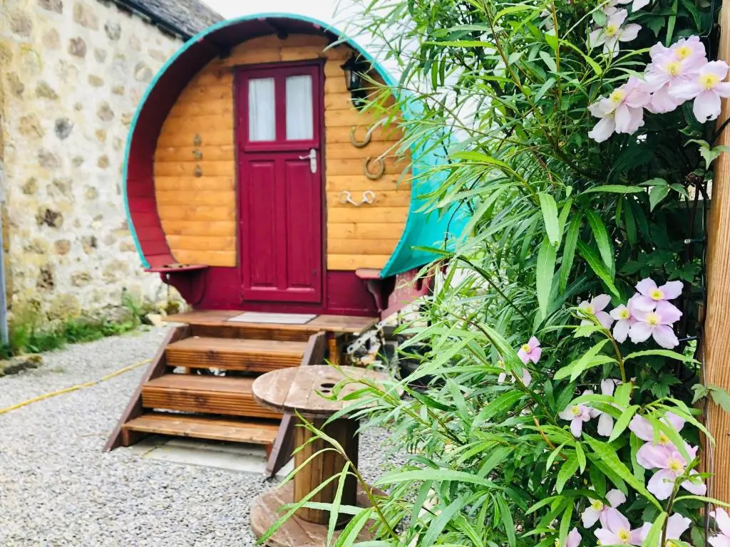 a door to a small house with a bench in front at Bowtop Wagon at Lettoch Farm in Keith