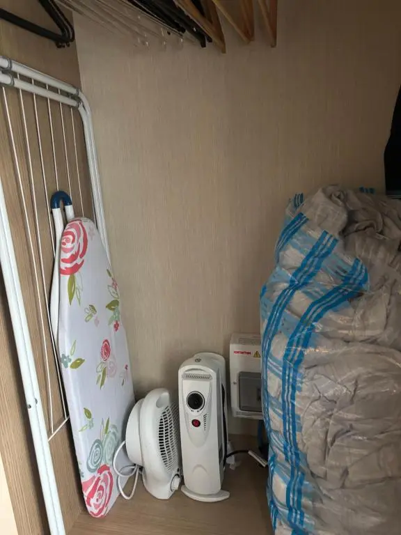a room with a bed and a dorm room with a surfboard at Silversands Holiday Park in Lossiemouth