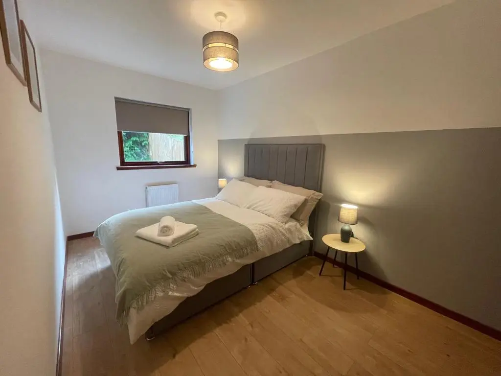 a bedroom with a bed with a white tray on it at Meggies Place in Inverness