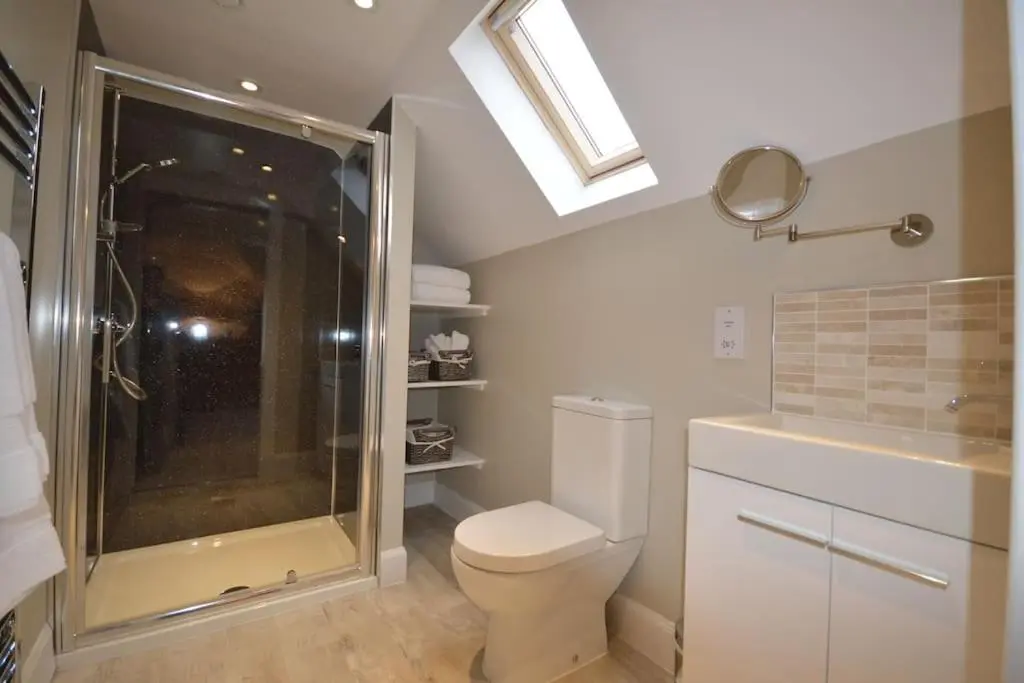 a bathroom with a shower and a toilet and a sink at Cray House - Large Country Home in Perthshire in Cray