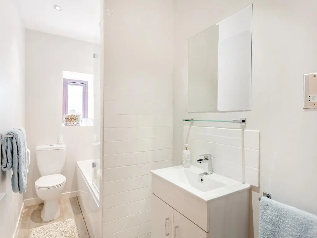 a white bathroom with a sink and a toilet at Mid Bellandy in Ballindalloch