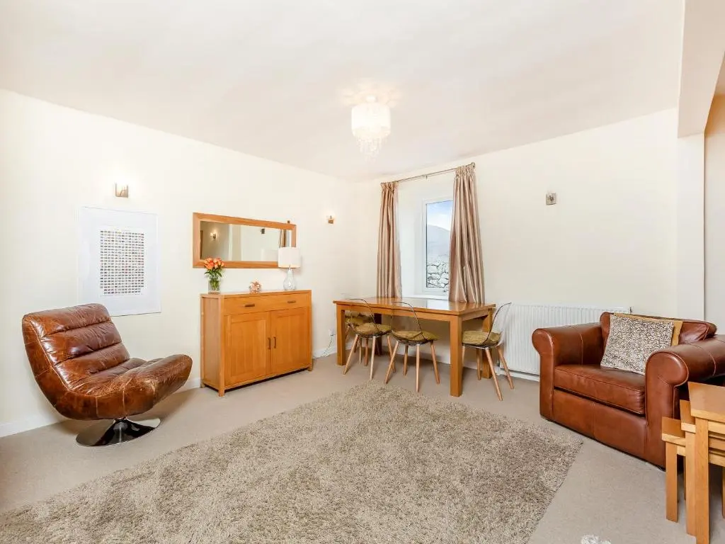 a living room with a desk and a chair at Mid Bellandy in Ballindalloch