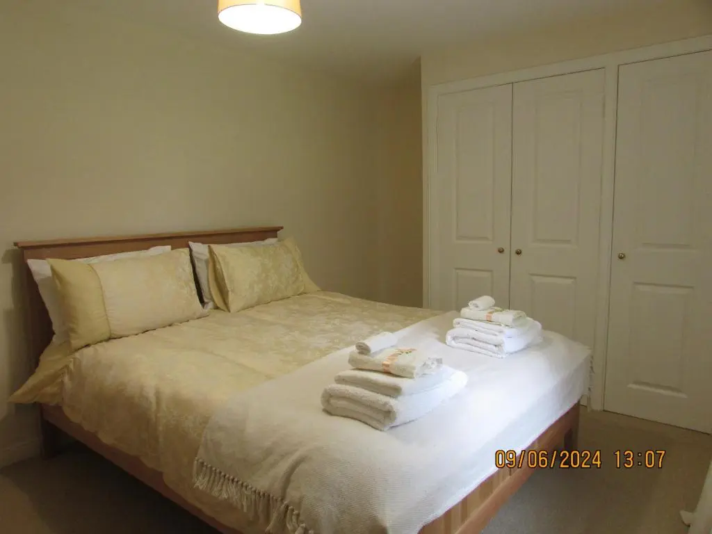 a bedroom with a bed with towels on it at Culloden Stables 4 in Inverness