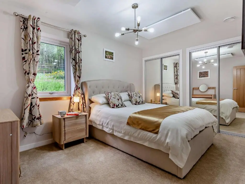 a bedroom with a large bed and a window at 2 Bed in Kiltarlity 95056 in Kiltarlty