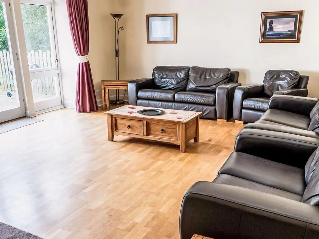 a living room with couches and a coffee table at Holiday Home Old Stables by Interhome in Drumnadrochit