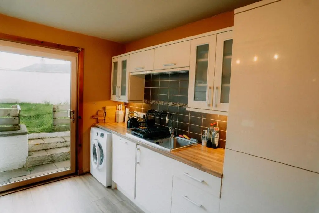 a kitchen with a sink and a dishwasher at Inverness Holiday House in Dalneigh
