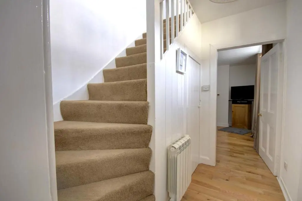 a staircase in a home with a stair case at Wilsons, Golspie in Golspie