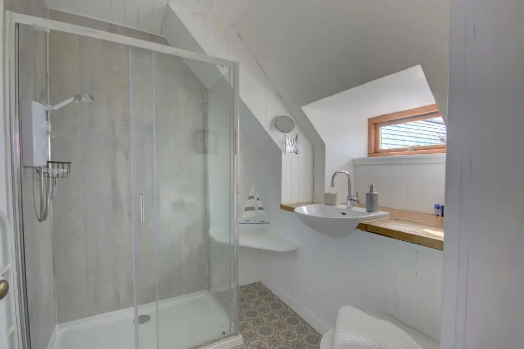 a bathroom with a shower and a sink at Wilsons, Golspie in Golspie