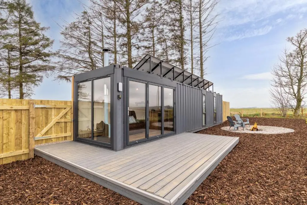 a tiny house on a deck in a yard at The Off Grid Cabin in Insch