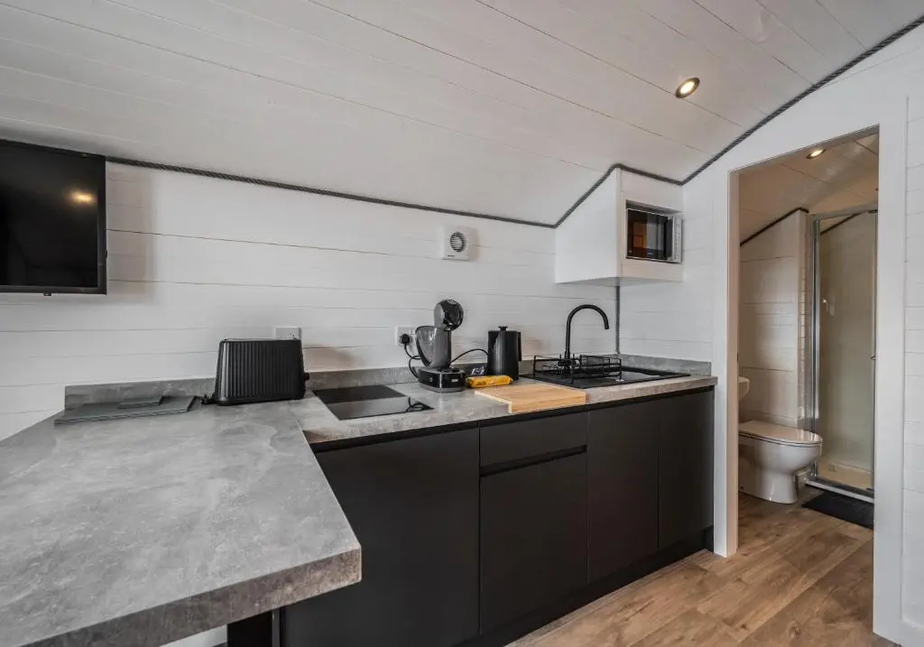 a kitchen with a sink and a counter top at Nessie Pod in Fort Augustus