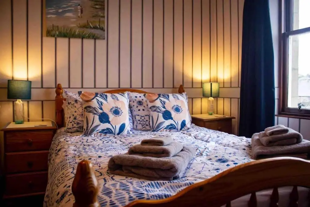 a bedroom with a bed with towels on it at Crannoch Self Catering - 10 bedroom former hotel in Cullen