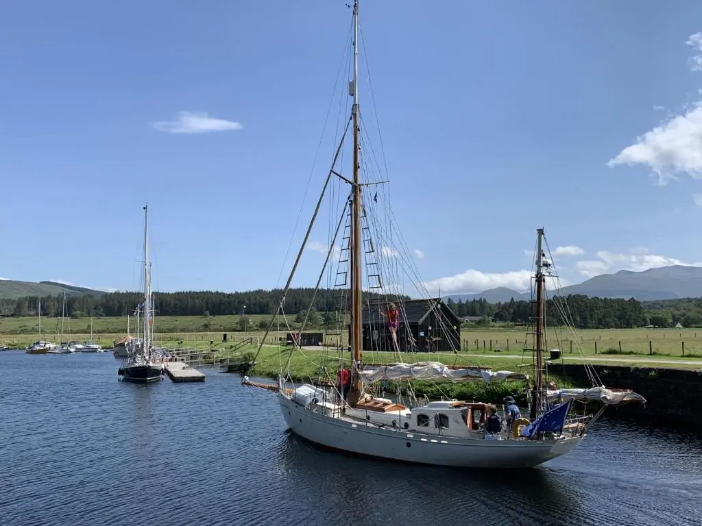 a boat is docked in a river with other boats at Chalet Loch Lochy Retreat by Interhome in Spean Bridge