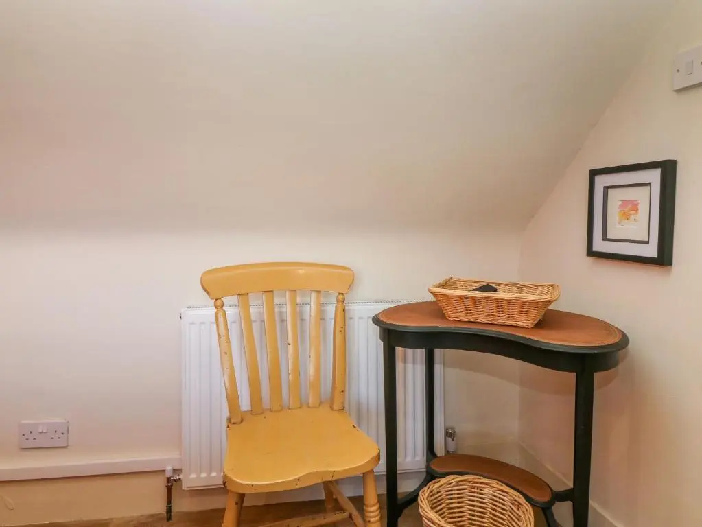 a wooden chair and a table in a room at 1A Carmelite Street in Banff